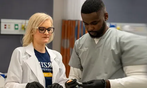 Nurse Educator Teaching Student in Labs