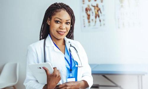 Women's health nurse practitioner with DNP smiling in clinic